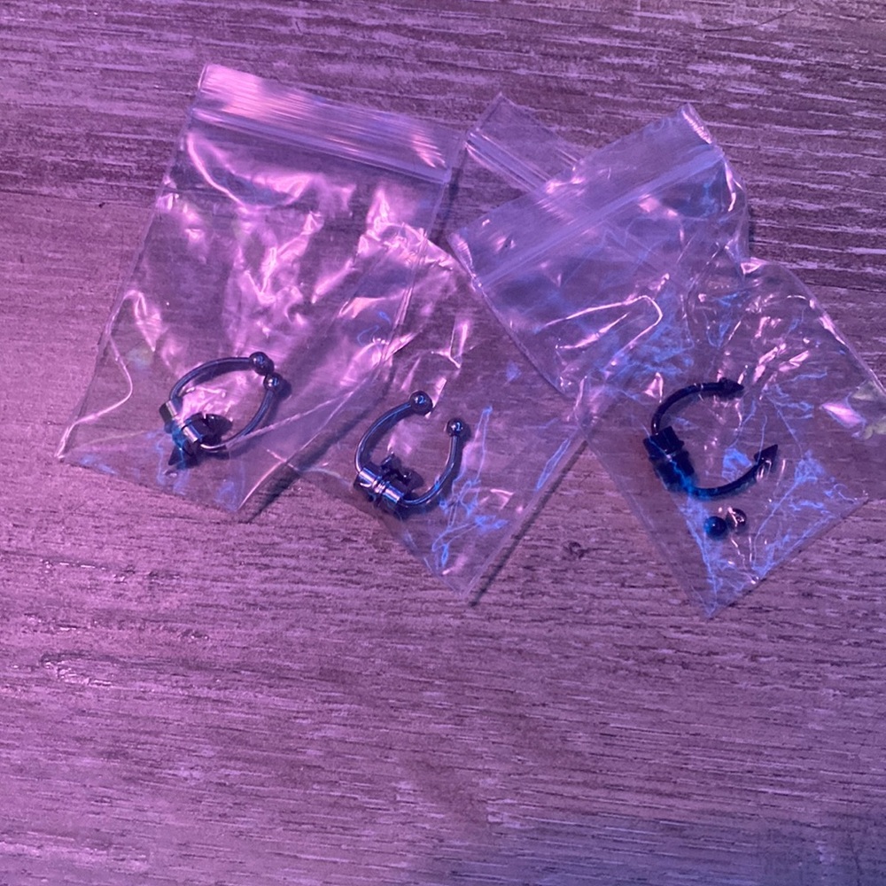 Three septum magnetic piercings.